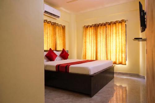 a bedroom with a bed with red pillows and a window at Astoria House in New Town