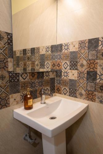 a bathroom with a white sink and a mirror at Astoria House in New Town