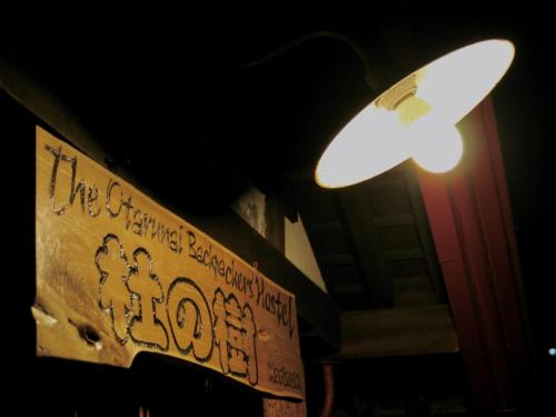 a street light and a sign with graffiti on it at The Otaornai Backpacker's Hostel Morinoki in Otaru