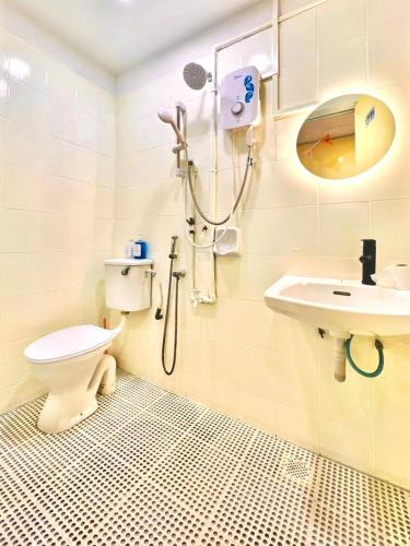 a bathroom with a shower and a toilet and a sink at Camp Fire Homestay 2602 in Mersing