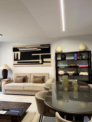 a living room with a couch and a table at Casa Amayuma - Málaga Centro Histórico in Málaga