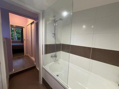 a bathroom with a shower and a bath tub at Flat Hills Tourist Park in Ruahine