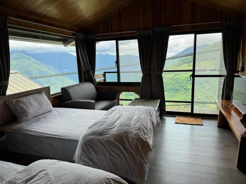 a bedroom with two beds and a view of mountains at Mo Huai Su-桃園市民宿085號 in Hualing