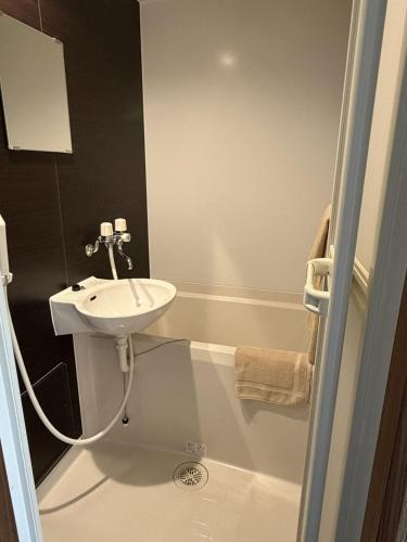 a small bathroom with a sink and a toilet at Hotel The Namie Terrace in Namie