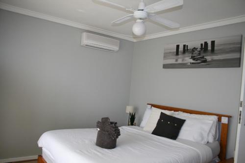 a bedroom with two beds and a ceiling fan at Budget Friendly Accommodation in Mandurah