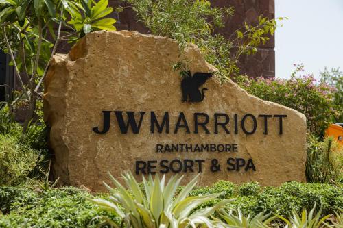 a sign for the jw marriot rainforest barbecue resort and spa at JW Marriott Ranthambore Resort & Spa in Sawāi Mādhopur