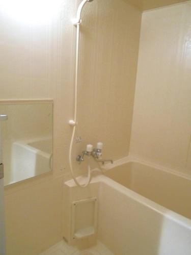 a bathroom with a tub and a shower with a mirror at メープル桑園駅202 in Sapporo
