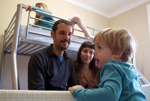 a man and a woman and a little boy on a bunk bed at Alberg Costa Brava in Llança