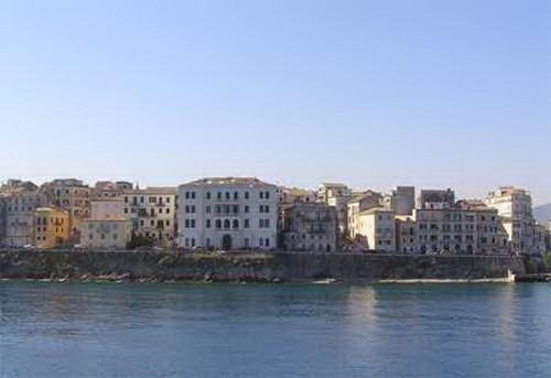 a group of buildings on the shore of a body of water at Sweet Memories Beach Houses in Mesongi