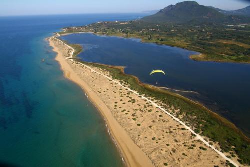an aerial view of a beach with a parachute at Sweet Memories Beach Houses in Mesongi