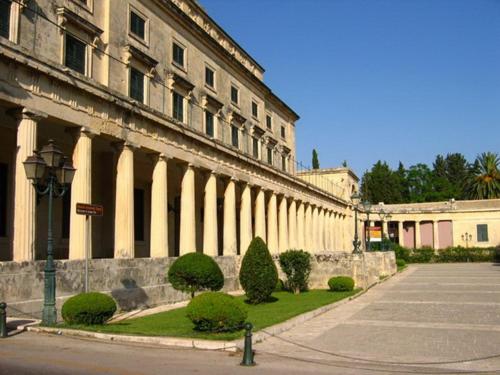 a large building with a street in front of it at Sweet Memories Beach Houses in Mesongi