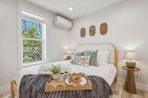 a bedroom with a bed with a tray of food on it at Timberline Flats in Traverse City
