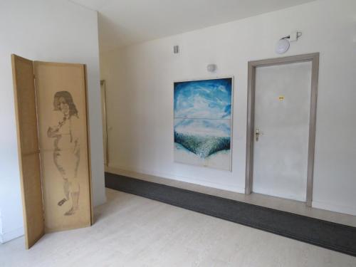 a room with two doors and a painting on the wall at Hotel Giardino in Breno