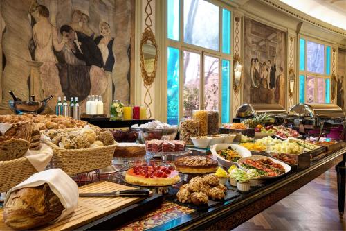 a buffet with many different types of food on a table at Grand Hotel Palace Rome in Rome