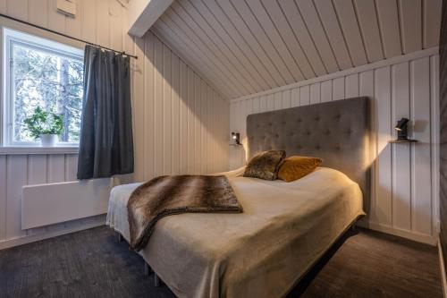 a bedroom with a large bed in a room at Bruna Byn in Sälen