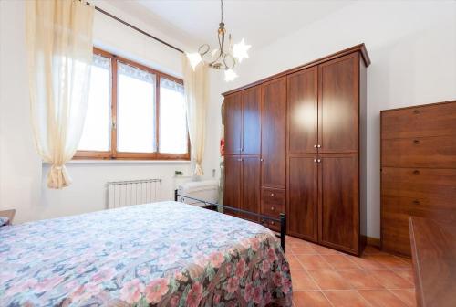 a bedroom with a bed and a wooden cabinet at A Different Side of Florence in Florence