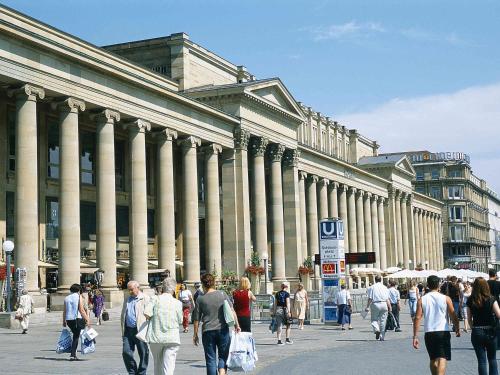 a group of people walking in front of a large building at Mercure Stuttgart Zuffenhausen in Stuttgart