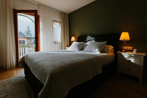 a bedroom with a large bed and a window at Lucy Villa in Băile Tuşnad