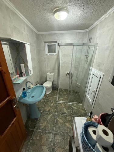 a bathroom with a shower and a sink and a toilet at BlueTown Fethiye in Fethiye