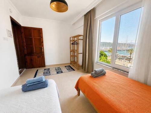 a bedroom with two beds and a large window at BlueTown Fethiye in Fethiye