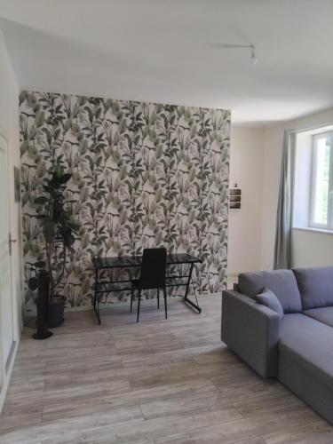 a living room with a couch and a table at Gîte Le 500 in Mayres