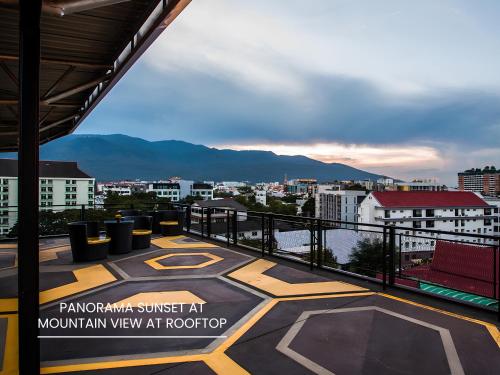 a balcony with a view of a city at The Hive Chiang Mai Hotel in Chiang Mai