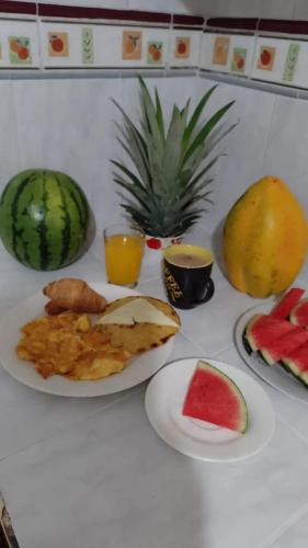 a table with plates of food and fruit on it at Hotel Iam Armenia Quindio in Armenia