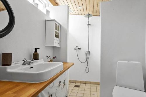 a bathroom with a sink and a shower at LF10211-Thyholm-Ronbakken-11 in Thyholm