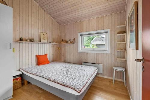 a small bedroom with a bed and a window at FY237-Otterup-Vestparken-6 in Otterup