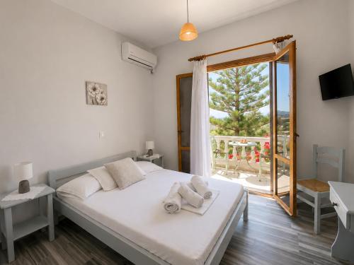 a bedroom with a bed with towels on it at Stelios Zalonis Apartments in Tinos