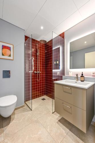 a bathroom with a toilet and a sink and a shower at The Break Hotel in Herning