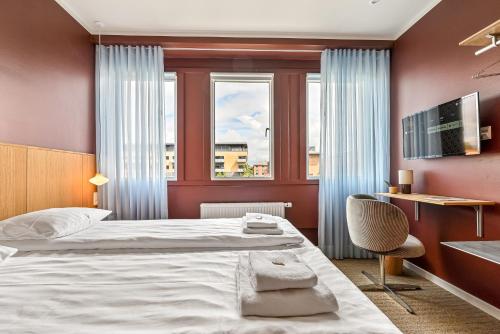 a hotel room with a bed and a window at The Break Hotel in Herning