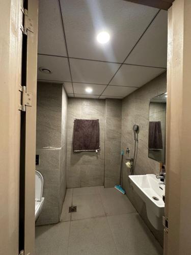 a bathroom with a sink and a toilet at D Haven Stays in Greater Noida