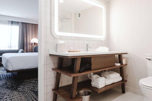a bathroom with a sink and a mirror at Radisson Hotel Santa Maria in Santa Maria