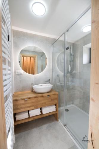 a bathroom with a sink and a shower at Chata Bergen in Vysoké Tatry