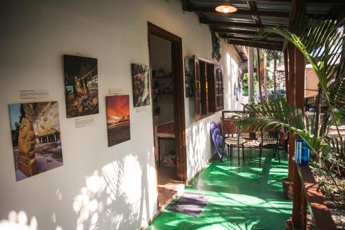 a house with a green floor and posters on the wall at Liv Bumi Oasis in Pantai Cenang