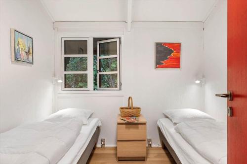 two beds in a room with two windows at JB353-Brovst-Hjortevaenget-13 in Brovst