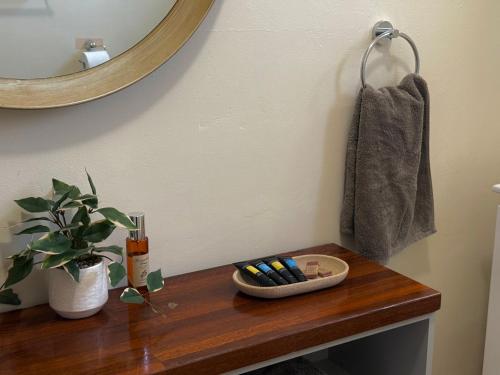 a table with a mirror and a bowl of toothbrushes at Kimba Units - Better than a motel room - self contained and pet friendly in Kimba