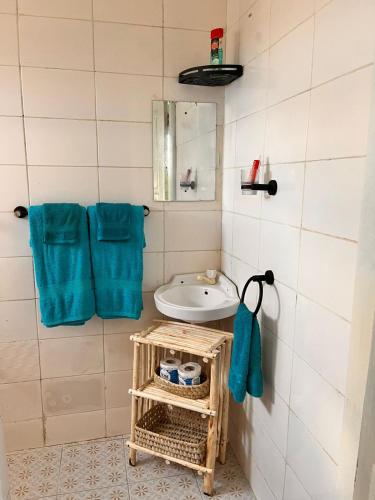 a bathroom with a sink and a mirror at Khangadelic Kilifi in Kilifi