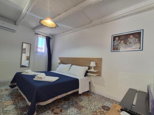 a bedroom with a bed and a television in it at Anima Templi in Agrigento