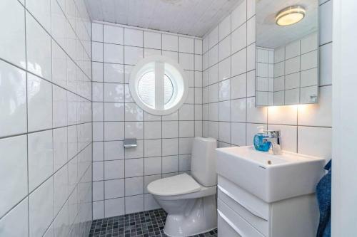 a white bathroom with a toilet and a sink at VGO1064-Karlsborg-Silverdalen-1 in Karlsborg