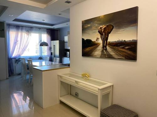a kitchen with a painting of an elephant on the wall at Just home in Hamina