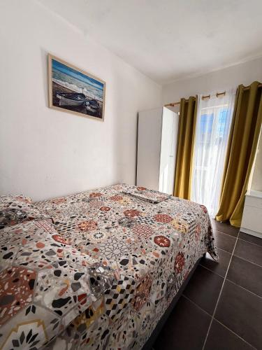 a bedroom with a bed with a comforter on it at Willy Apartments in Velipojë