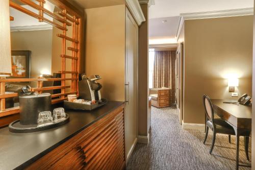 a hotel room with a desk and a room at Curtiss Hotel, an Ascend Collection Hotel in Buffalo