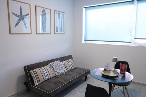 a living room with a couch and a table at Apartment Simply 101 in Gázion
