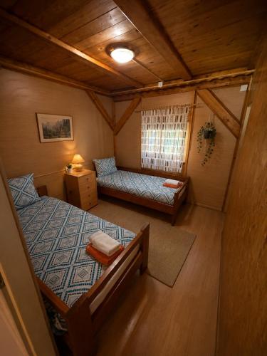 a small room with a bed and a couch at Bungalow Perun in Blejska Dobrava