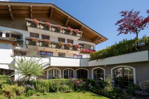 an apartment building with flowers on the balconies at Hubengut Bed and Breakfast in Radstadt