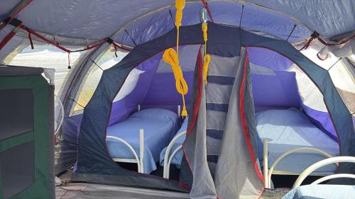 a tent with a bed in the inside of it at Agricampeggio Tenuta Ferrario in Baia Verde