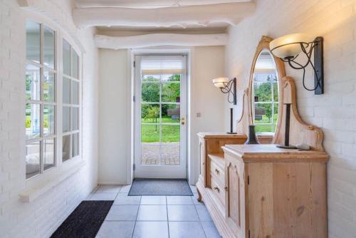 a hallway with a mirror and a vanity and a window at HS025-Outrup-Strandvejen-31-B in Henne
