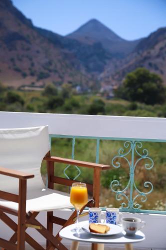 a table with a glass of orange juice on a balcony at Apartment Simply 203 in Gázion